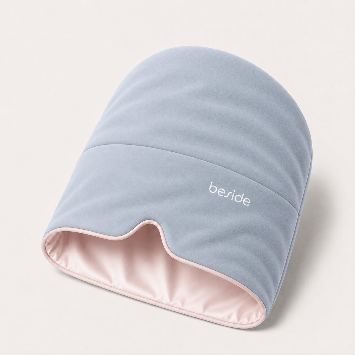 Blushing Sky weighted Sleep Hood in light blue with a blush pink lining, shown on white.