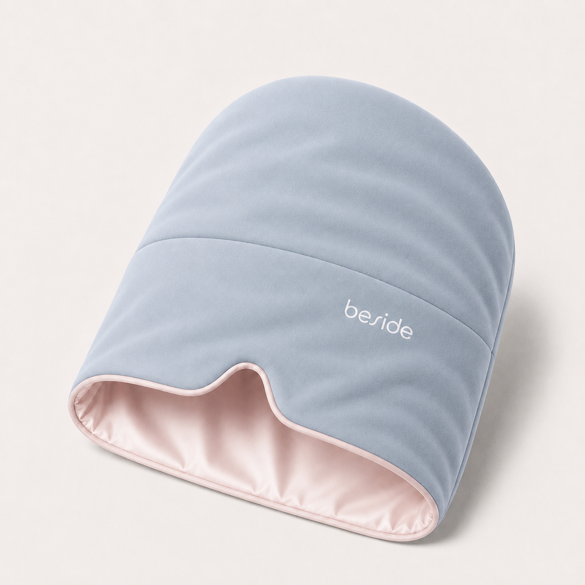 Blushing Sky weighted Sleep Hood in light blue with a blush pink lining, shown on white.